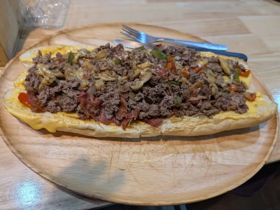 The Super 12" Ultimate cheesesteak at Mano's, Pattaya - shaved beef, smokey bacon, mushrooms, bell peppers and onions topped with melted cheese on a 12-inch hoagie